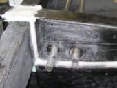 The left wing root rib, showing the push-pull tube exits and the mounting holes for the auto-connect bellcrank brackets.
